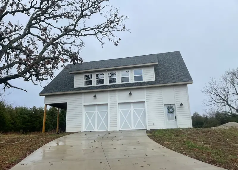 Home with a completed dark shingle roof
