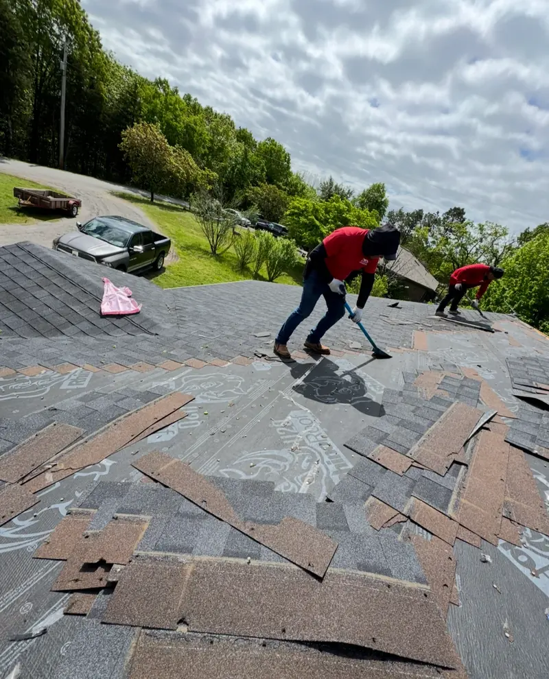 Roofer installing architectural shingles